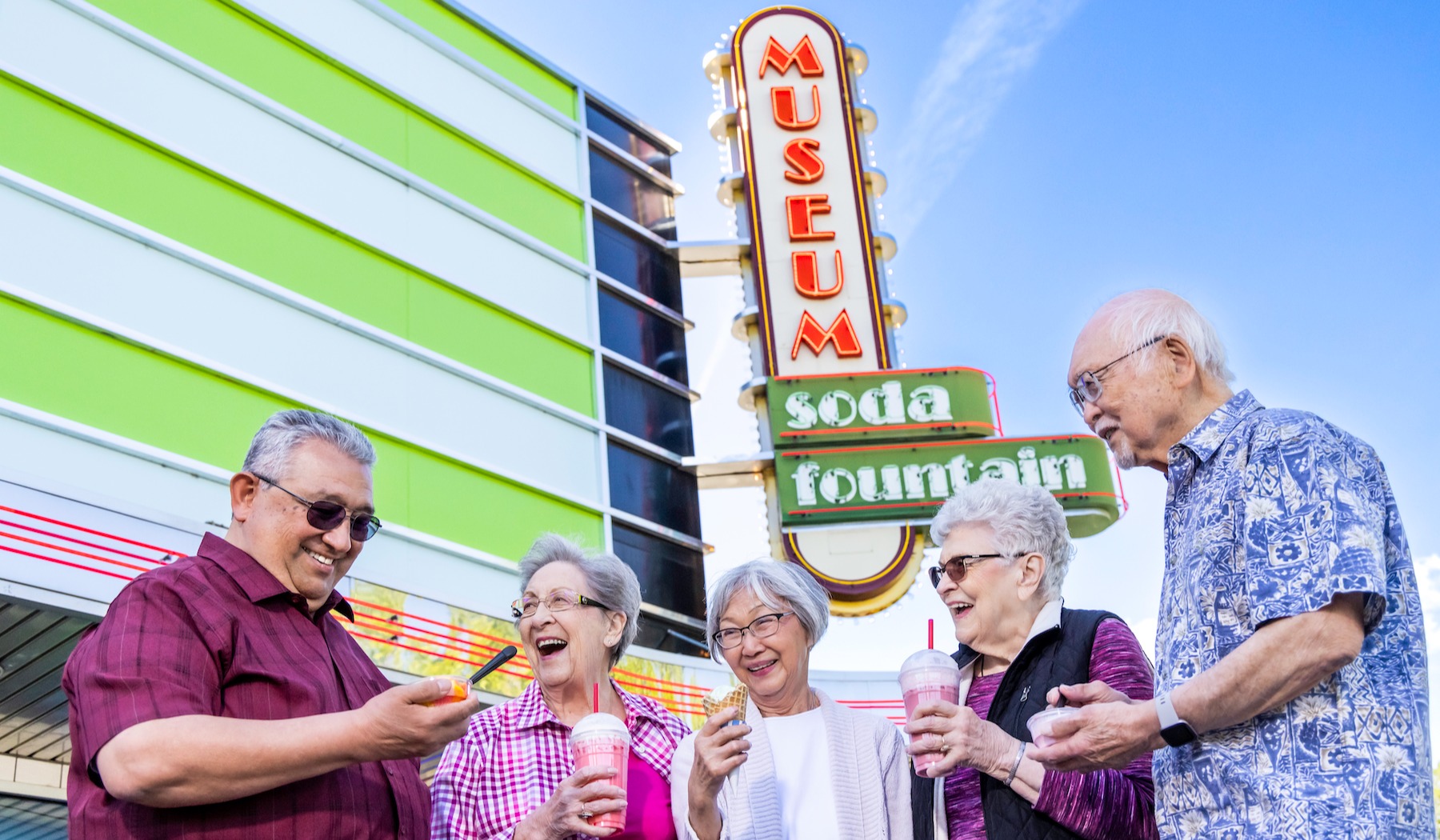 Group of friends in front of museum sign